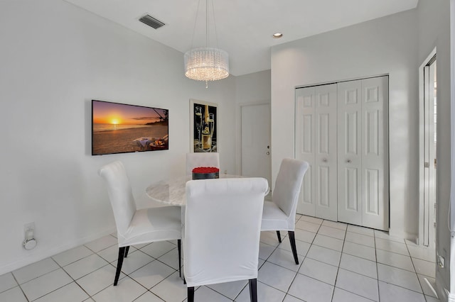 tiled dining area with an inviting chandelier