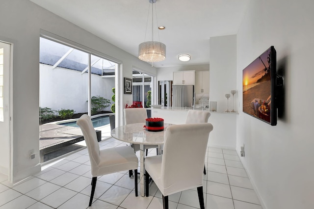 tiled dining space featuring a notable chandelier