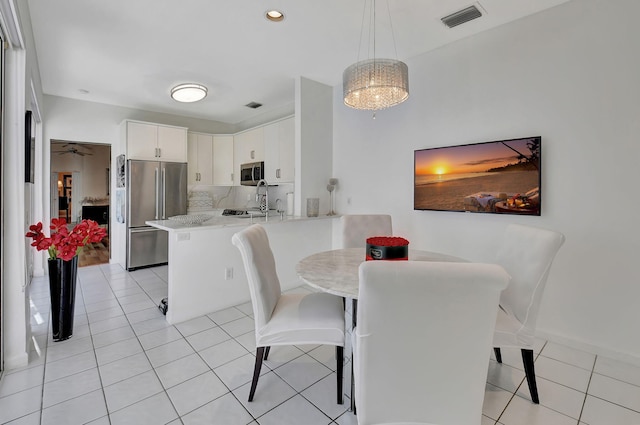 tiled dining area with ceiling fan