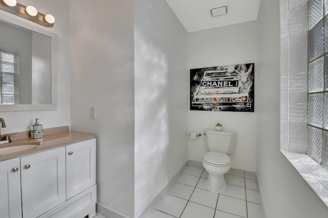 bathroom with tile patterned flooring, vanity, and toilet