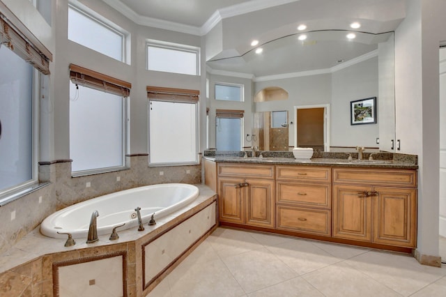 bathroom with tile patterned flooring, separate shower and tub, crown molding, and vanity