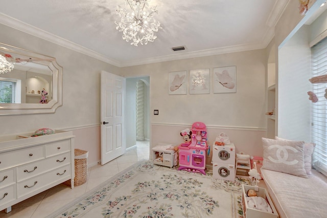 recreation room with ornamental molding, a chandelier, and light tile patterned floors