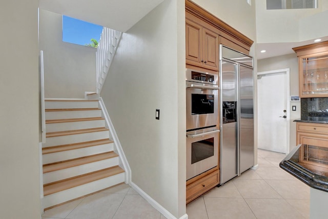 kitchen with stainless steel appliances and light tile patterned floors