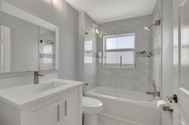 full bathroom featuring toilet, vanity, and tiled shower / bath