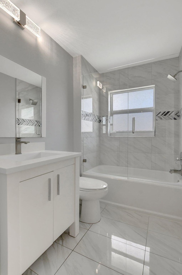 full bathroom with toilet, tiled shower / bath, and vanity