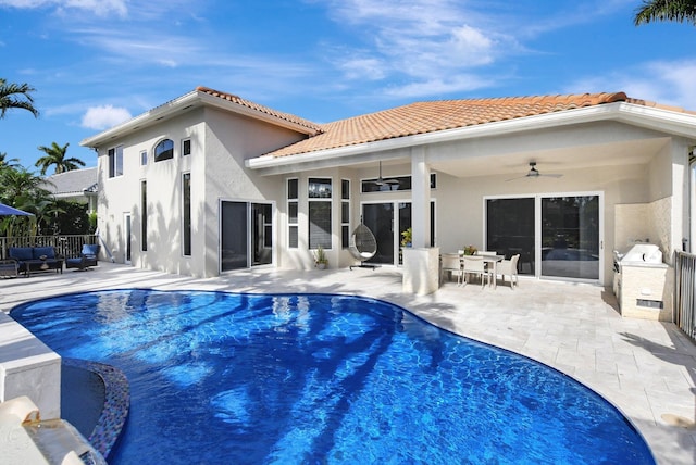 back of house with ceiling fan and a patio area