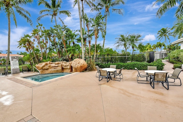 view of pool featuring a community hot tub and a patio area