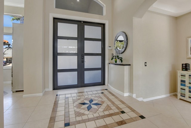 tiled entrance foyer featuring french doors