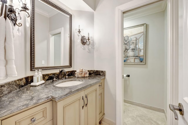 bathroom featuring tile patterned flooring, crown molding, and vanity