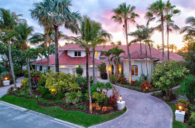 mediterranean / spanish home featuring a garage