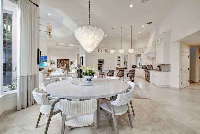 dining room with a high ceiling and a chandelier