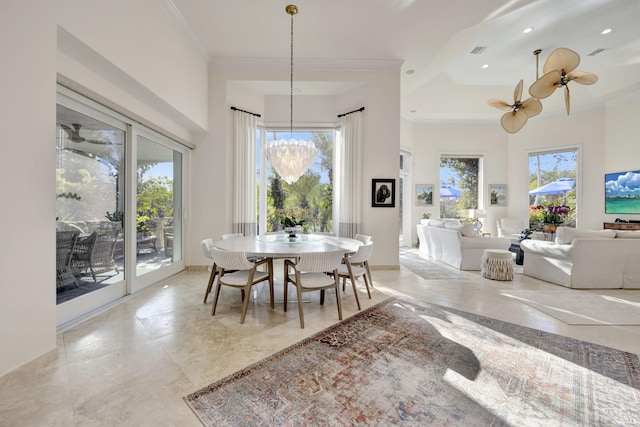 dining room featuring ceiling fan with notable chandelier and crown molding