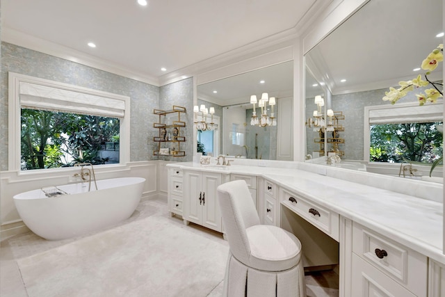 bathroom with vanity, a bathtub, and crown molding