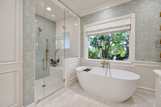 bathroom featuring ornamental molding and separate shower and tub