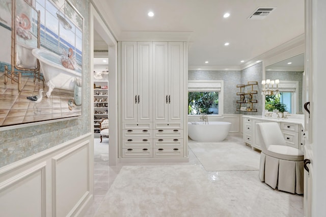 bathroom featuring a bathing tub, crown molding, and vanity