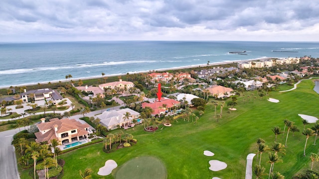 birds eye view of property featuring a beach view and a water view