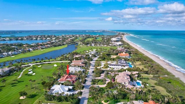 drone / aerial view with a beach view and a water view