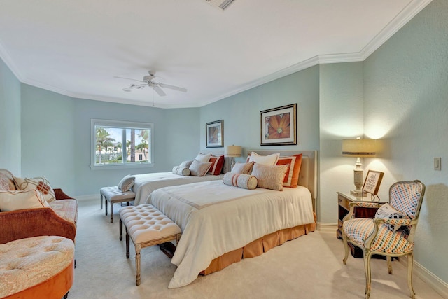 carpeted bedroom with ceiling fan and ornamental molding