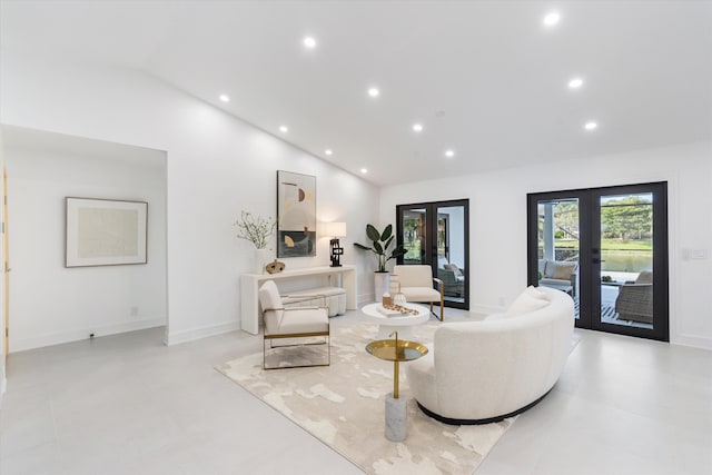 living room featuring vaulted ceiling and french doors