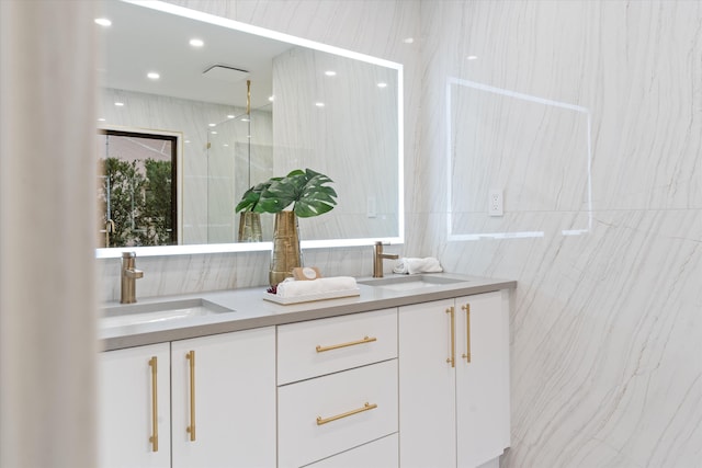 bathroom featuring vanity, tile walls, and a shower with shower door