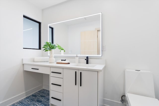 bathroom featuring tile patterned flooring, vanity, and toilet