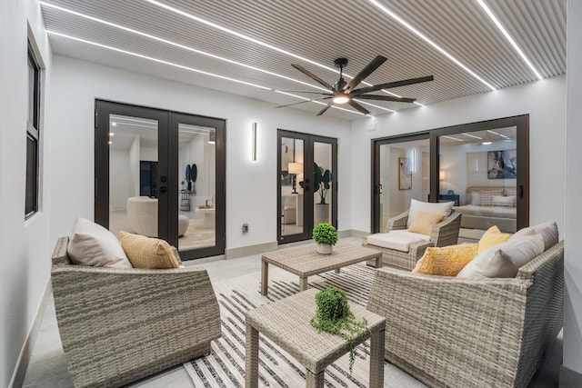 living room featuring french doors and ceiling fan