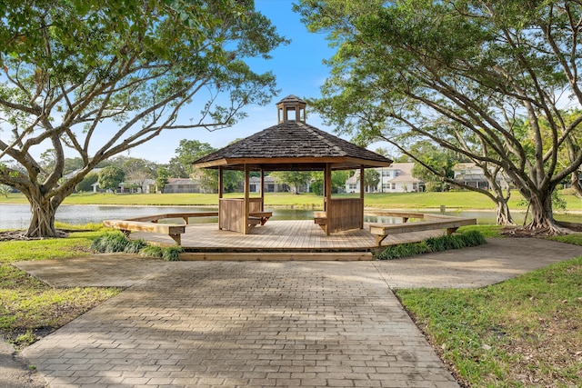 surrounding community with a gazebo and a water view