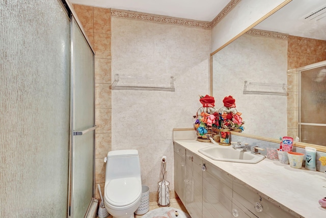 bathroom featuring an enclosed shower, vanity, toilet, and tile patterned floors