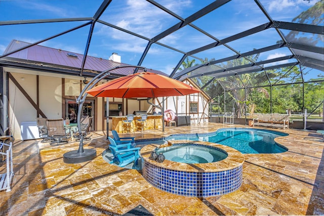 view of pool featuring a lanai, a patio area, an outdoor bar, and an in ground hot tub