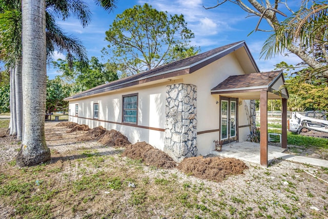 view of side of property featuring a patio