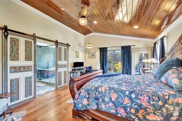 bedroom featuring a barn door, ornamental molding, vaulted ceiling, and hardwood / wood-style flooring