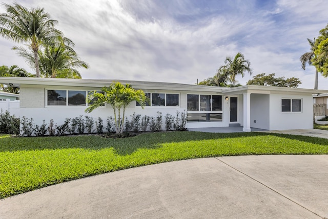 ranch-style house with a front lawn