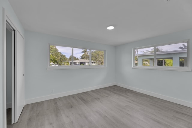 unfurnished bedroom featuring light hardwood / wood-style flooring and a closet