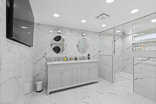 bathroom with vanity and a tile shower