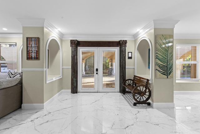 foyer entrance with ornamental molding and french doors