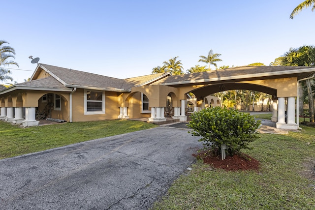 single story home featuring a front yard and a carport