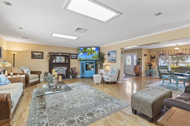 living room featuring light hardwood / wood-style floors and crown molding