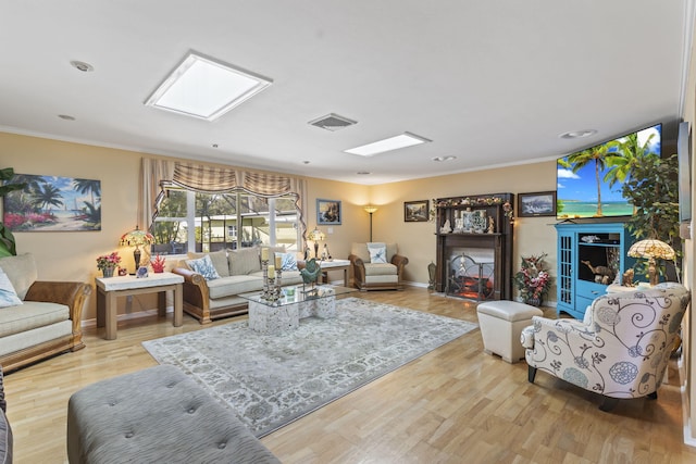 living room featuring light hardwood / wood-style floors and crown molding