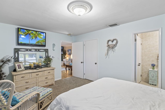 carpeted bedroom with ensuite bath