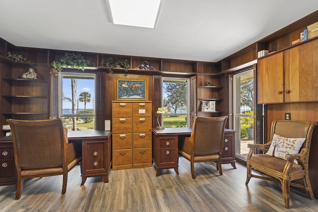 home office with a skylight and hardwood / wood-style floors