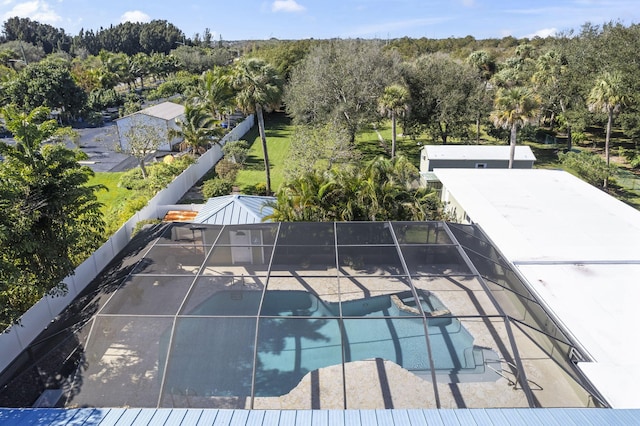 view of pool with a patio area and glass enclosure