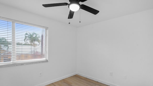 unfurnished room featuring plenty of natural light and wood-type flooring