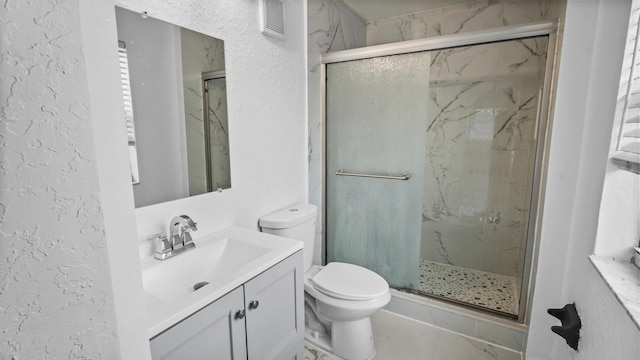 bathroom featuring vanity, toilet, and walk in shower