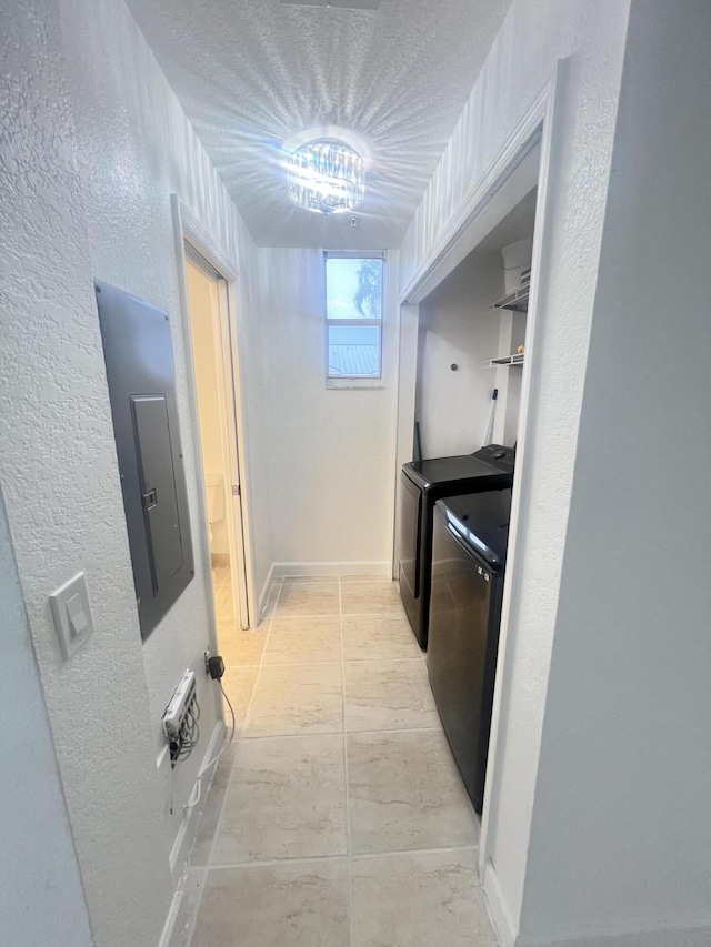 kitchen with electric panel and washing machine and clothes dryer