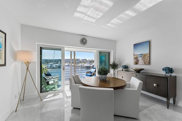 dining space featuring a water view