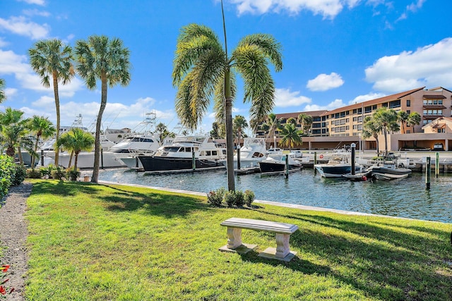 view of dock featuring a water view and a yard