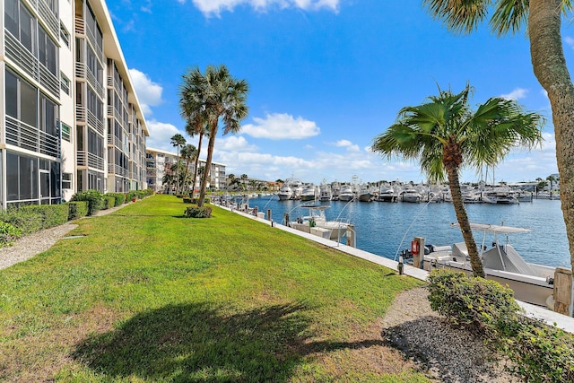 exterior space featuring a lawn and a water view