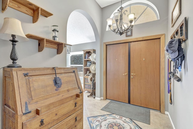 entrance foyer with light tile patterned floors, a healthy amount of sunlight, and a notable chandelier