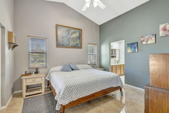 bedroom with connected bathroom, ceiling fan, light tile patterned flooring, and multiple windows