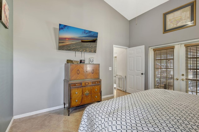 bedroom featuring light tile patterned floors and high vaulted ceiling